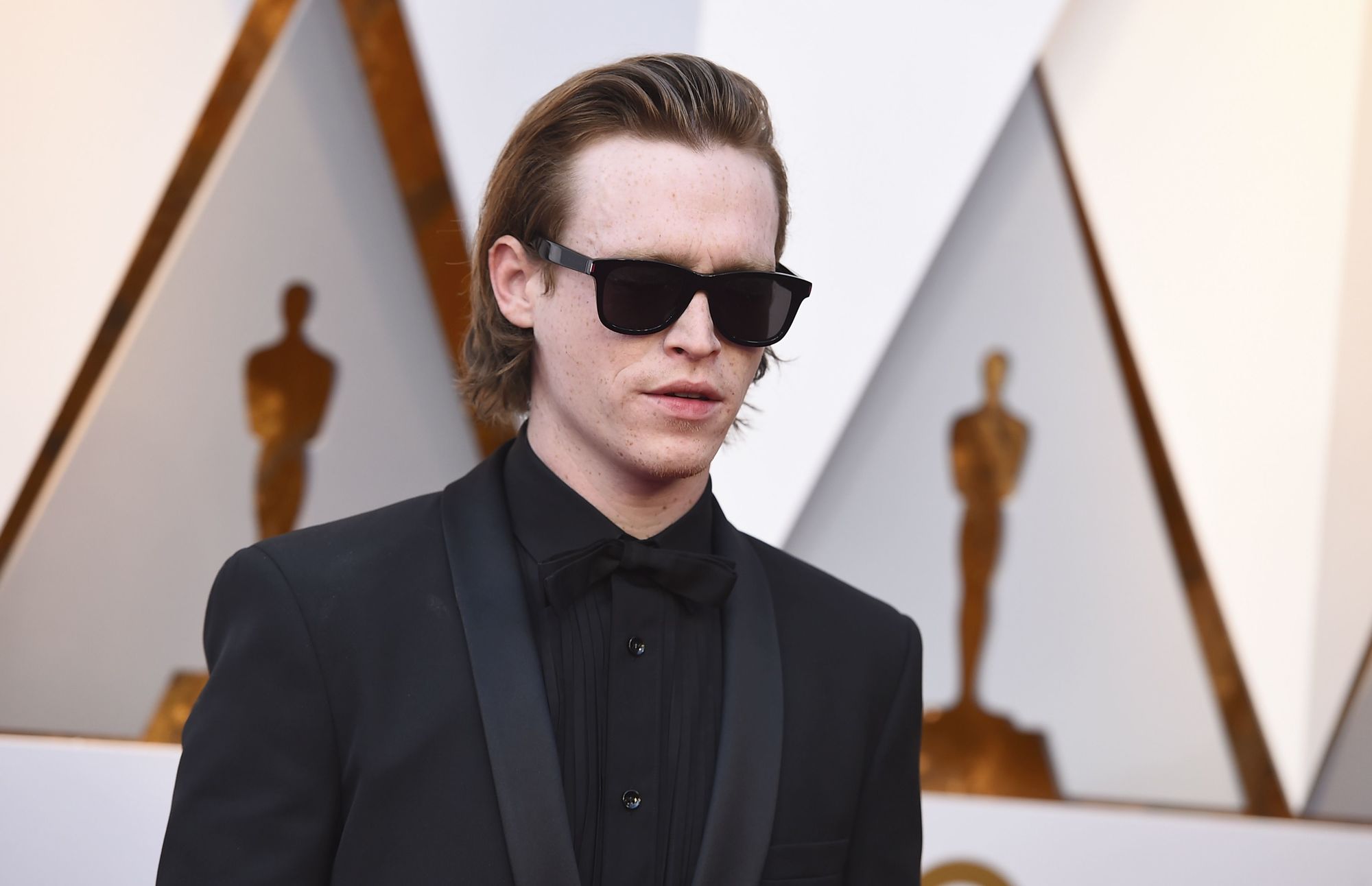 close up shot of caleb landry wearing swept back hairstyle, black suit jacket at the 90th Academy Awards