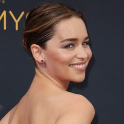 Game of Thrones actress Emilia Clarke on the red carpet with her brunette hair in a sleek low bun