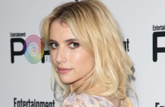 emma roberts wearing a floral dress with bleached blonde long hair