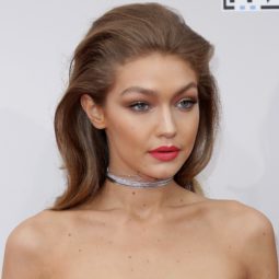 gigi hadid wearing strapless dress and red lipstick with relaxed quiff rockabilly hairstyle