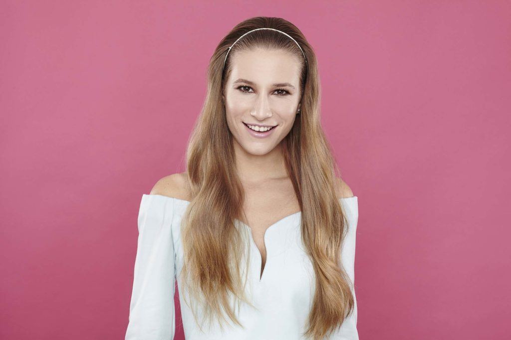 girl with long wavy light brown hair and white headband