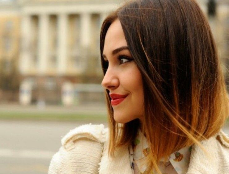 ombre short hair: woman with ginger spiced ombre straight hair wearing red lipstick.