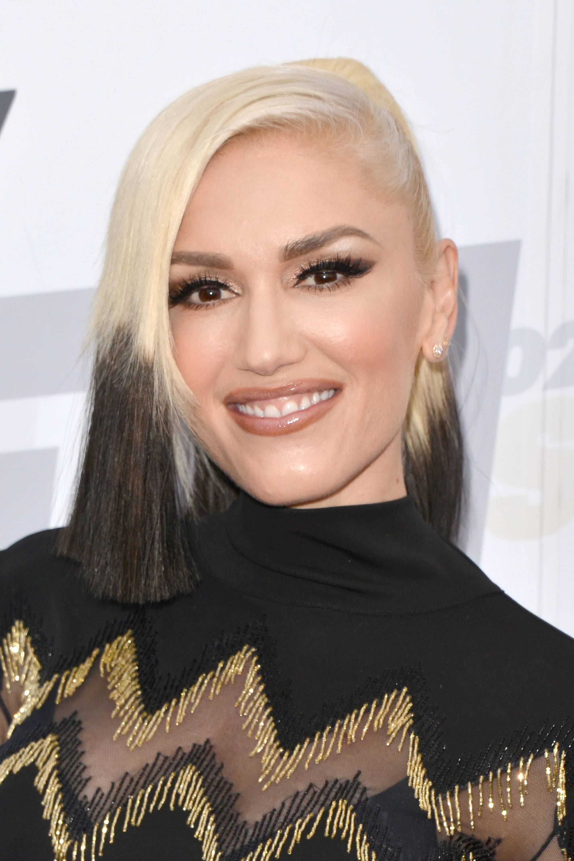 gwen stefani wearing a black roll neck dress with blonde and brown colour block hair