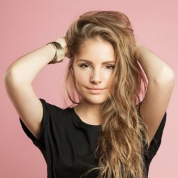 model with her hands in her light brunette hair