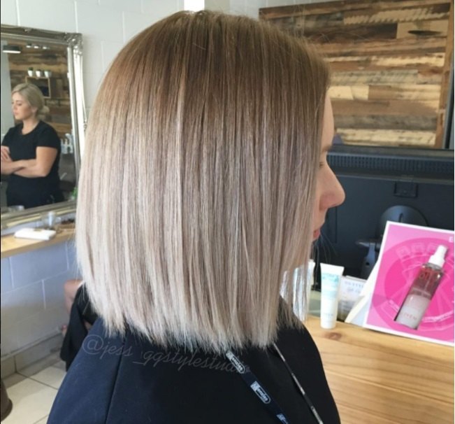 Ombre short hair: woman with short lob length hair coloured melted with blonde to platinum hair