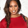 laverne cox in a red one shoulder dress with her brunette hair in a fishtail braid