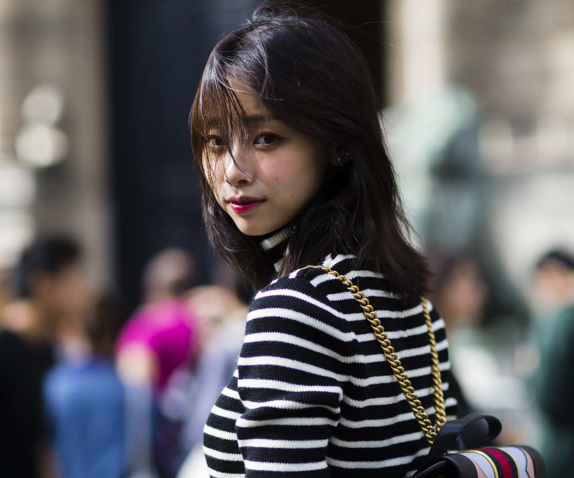 streetstyle shot with woman with lob hairstyle in striped shirt