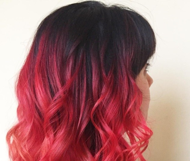 short ombre hair: woman with cherry red ombre on dark brown wavy hair