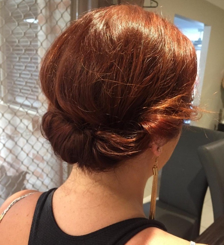 hairstyles for short hair for school: ginger woman with short hair styled into a rolled updo