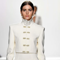 model on the runway of the jonathan simkhai aw17 show wearing a white outfit with her dark brown hair pulled back into a neat ponytail
