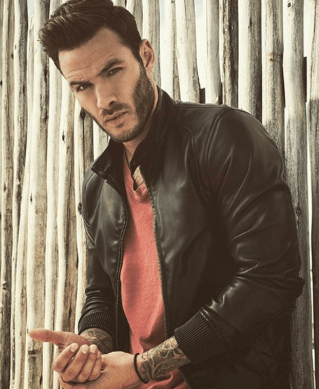 front view image of a man with a quiff hairstyle wearing a leather jacket