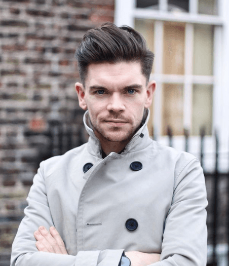 front view image of a man with dark hair and a quiff hairstyle