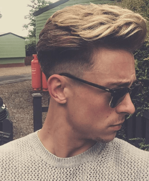 side view image of a man with blonde hair in a quiff style