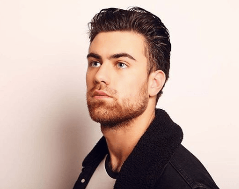 front view image of a man with slick back hair in a quiff style