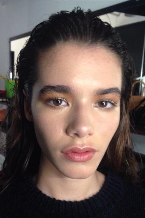 school hairstyles for short hair: brunette model with slicked back wet look hair