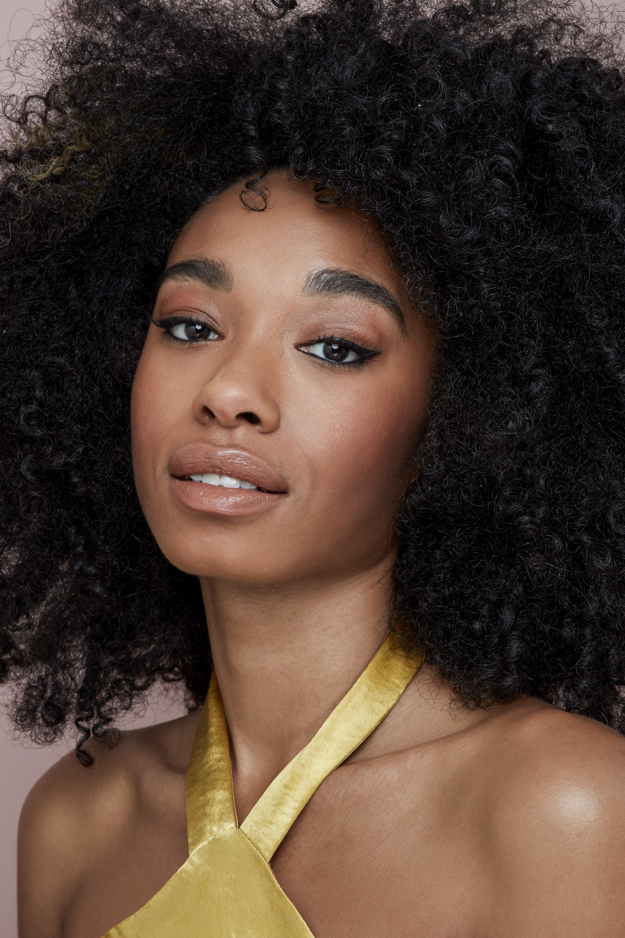 Natural hairstyles for Valentine's Day: Shot of model with big and beautiful natural afro, wearing a yellow dress
