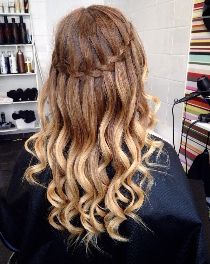 Waterfall hairstyle: woman with ombre brunette and blonde hair styled into a waterfall braid