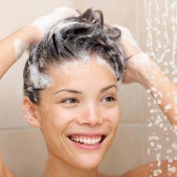 Woman lathering shampoo into her hair