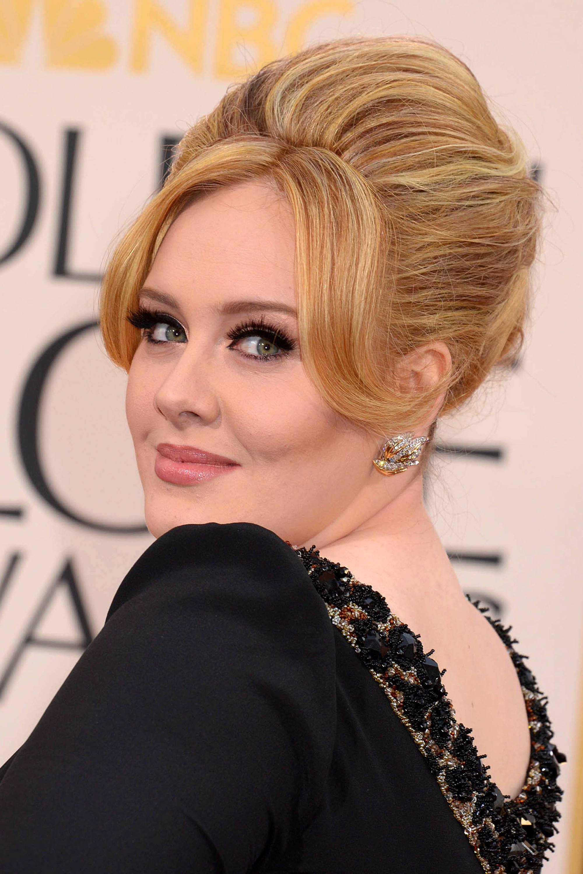 adele in a black dress with a beehive mod hairstyle