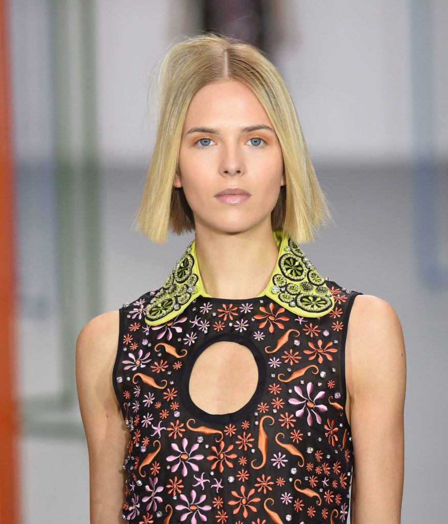 fashionable short hairstyles: blonde model on the runway with a blunt cut bob