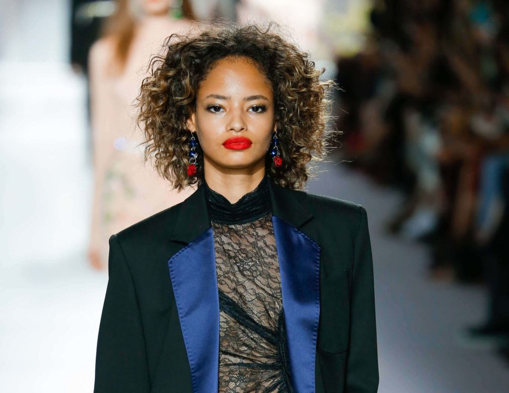 model short hair: natural haired model with big loose curls