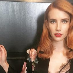 emma roberts with orange hair colour with red lipstick wearing a kimono