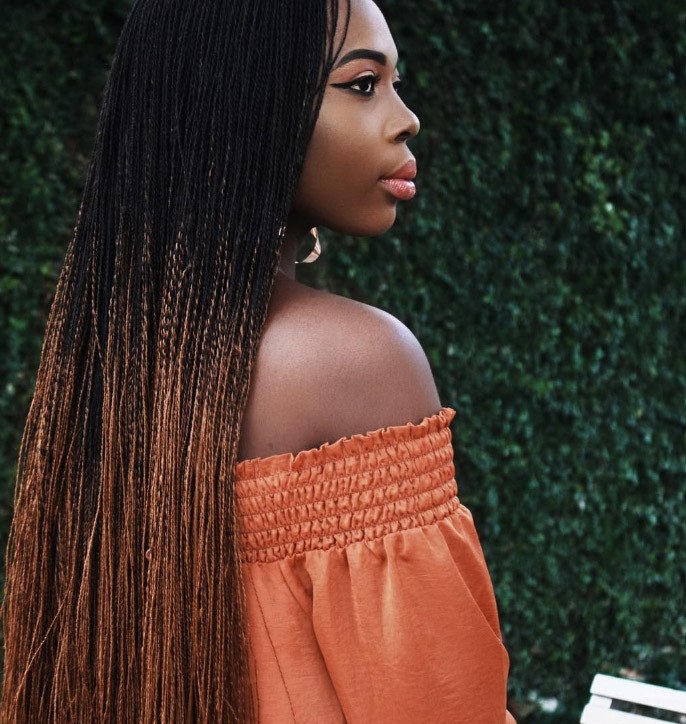 ombre micro braids hairstyles: woman with long braided hairstyle done in ombre