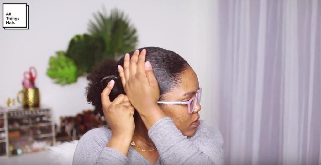 vlogger mini marley brushing her hair into a low puff