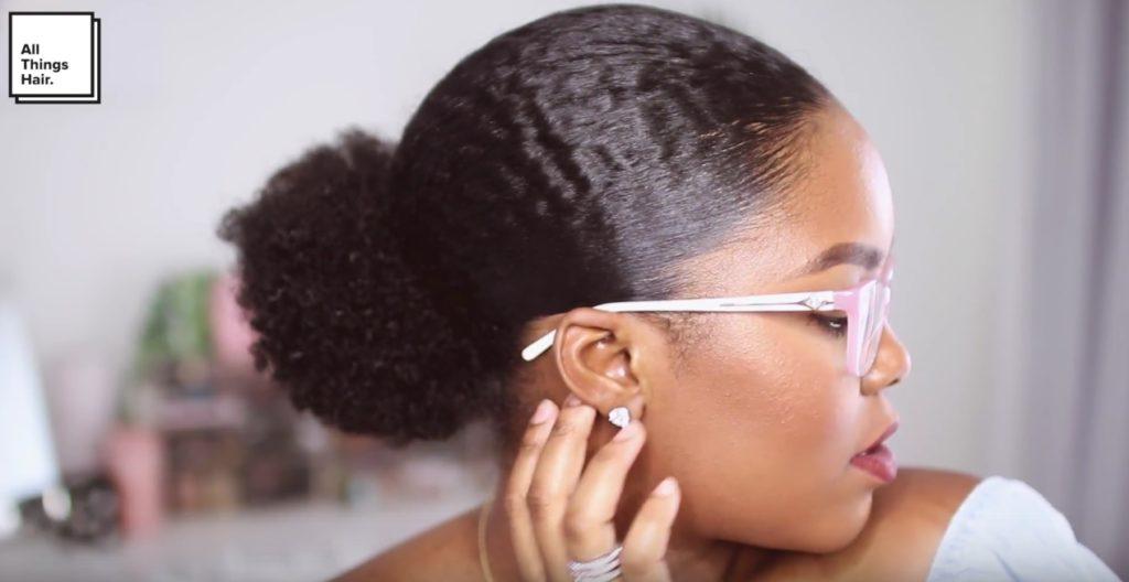 vlogger mini marley with a slick low puff hairstyle