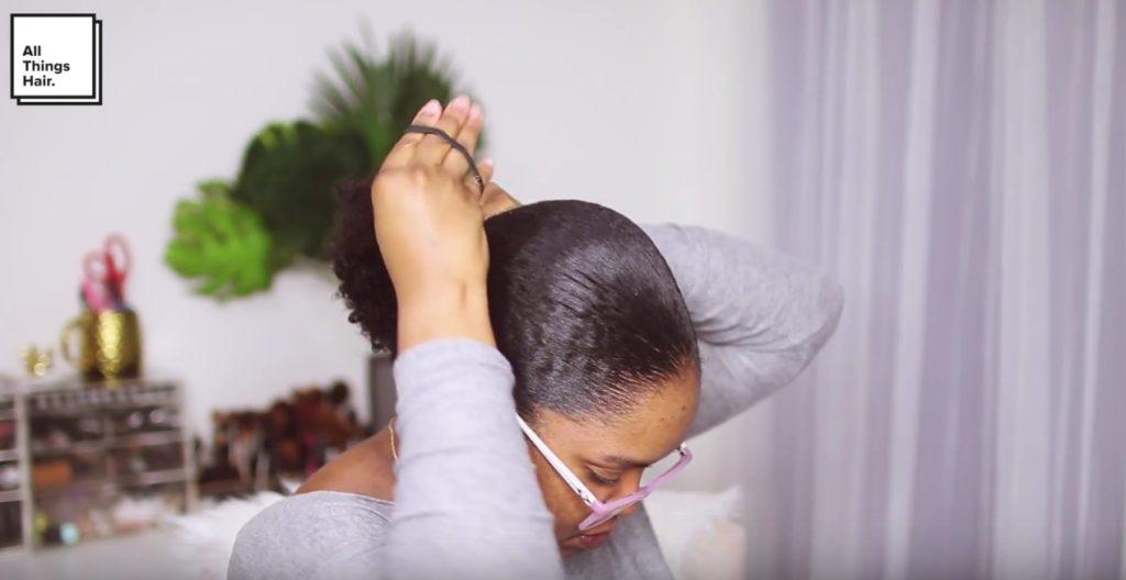 vlogger mini marley securing her low puff with a hairband