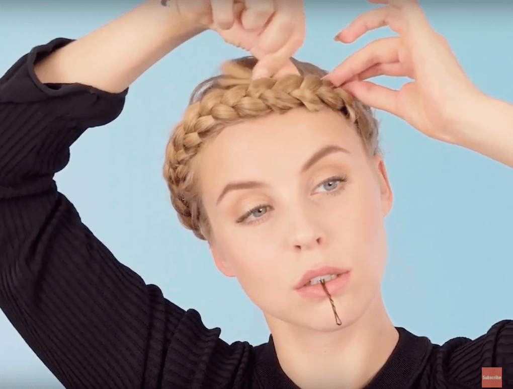 front view of blonde model wrapping braid for halo braid tutorial