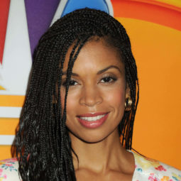 susan kelechi watson with small box braids swept to the side, wearing floral dress