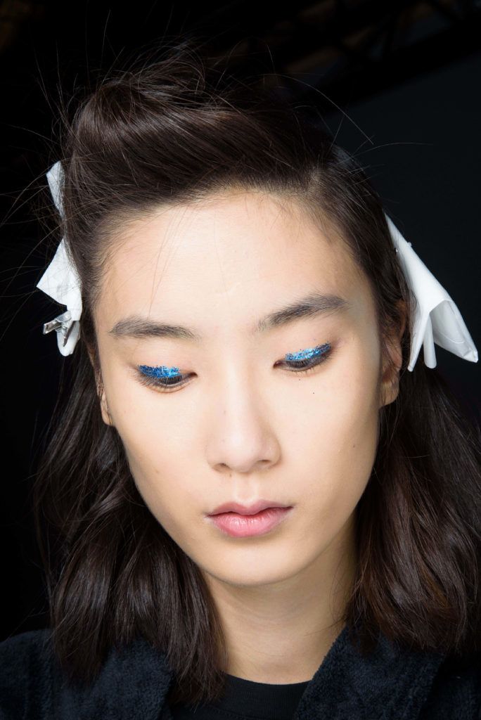 short hair fashion: asian model with a long bob styled into a quiff with accessories