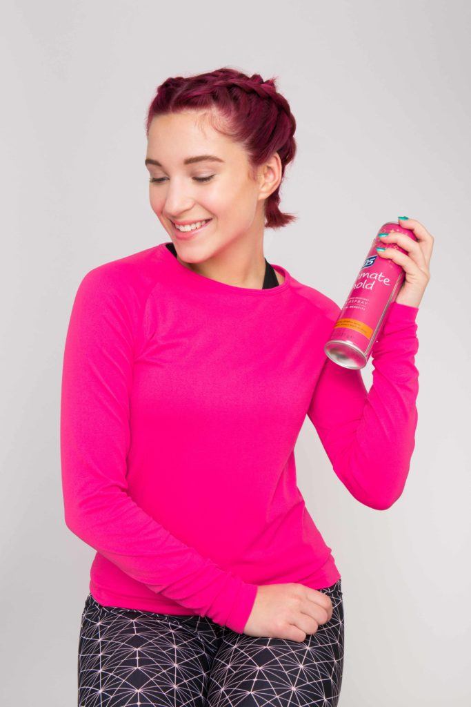 Double Dutch braids: red haired model with double Dutch braid sprays with hairspray
