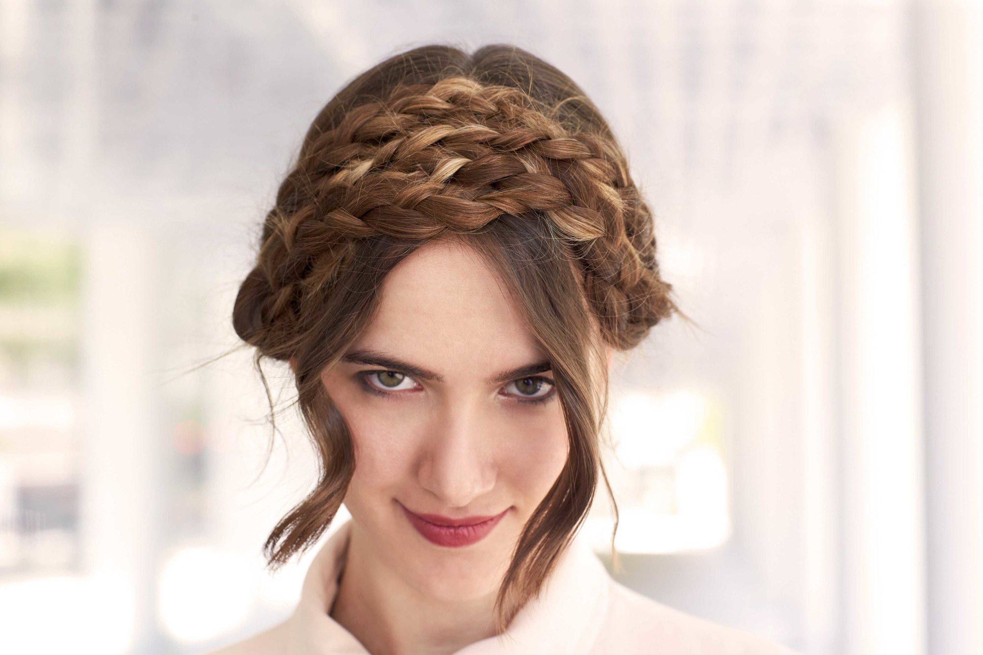long hairstyles for natural waves: double milkmaid braids as demonstrared by a model with long wavy hair