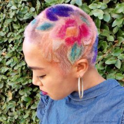 woman with a floral print rainbow buzz cut