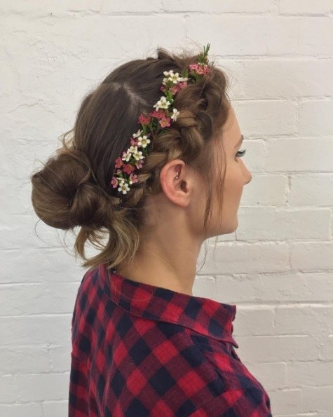girl wearing a red plaid shirt with braided bangs and a messy bun