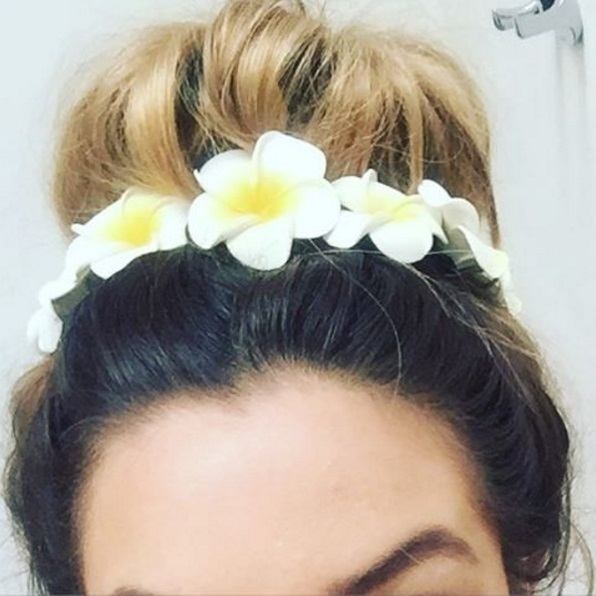 messy bun with flower hair accessories