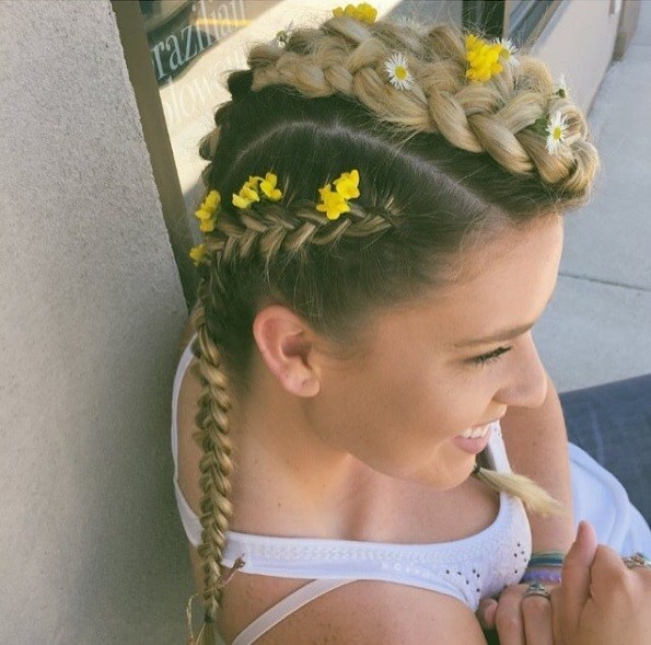 woman with mohawk braids with yellow flowers in