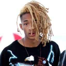 jaden smith with his blonde dreads in a tied up style wearing a printed tshirt