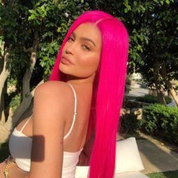kylie jenner at coachella festival wearing a hot florescent pink long straight wig