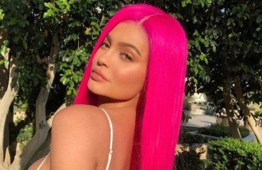 kylie jenner at coachella festival wearing a hot florescent pink long straight wig