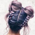coloured braids: close up shot of a woman with lilac braided space buns