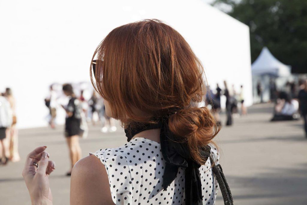 back view of a woman with a messy low bun - long hairstyles 2017