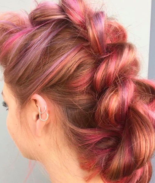 back view of a woman with colourful hair in a braided up do style