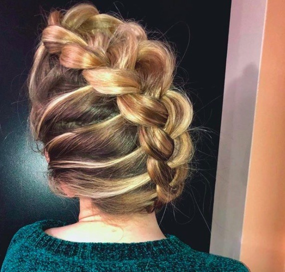 back view of a woman with a mohawk braid blonde up do