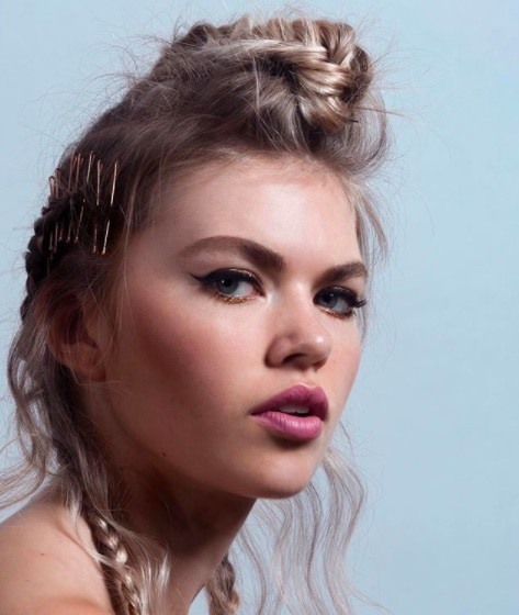 front view of a woman with blonde hair in a mohawk hairstyle with grips