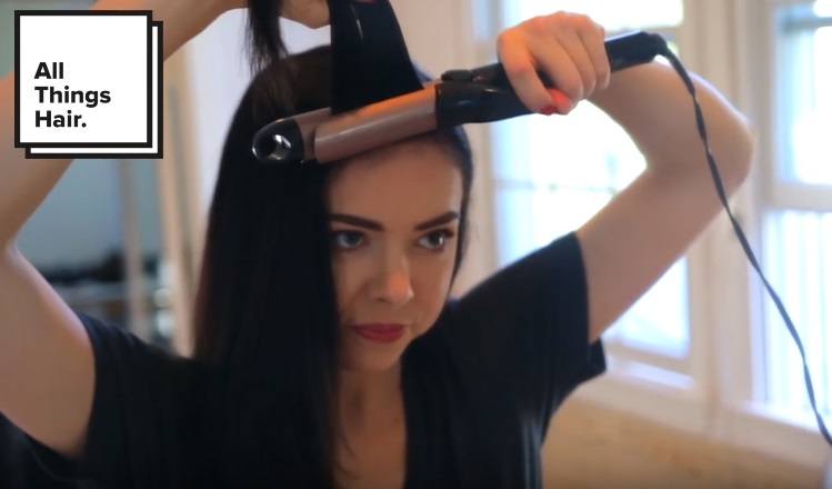 youtuber Nikki Phillippi curling her bangs