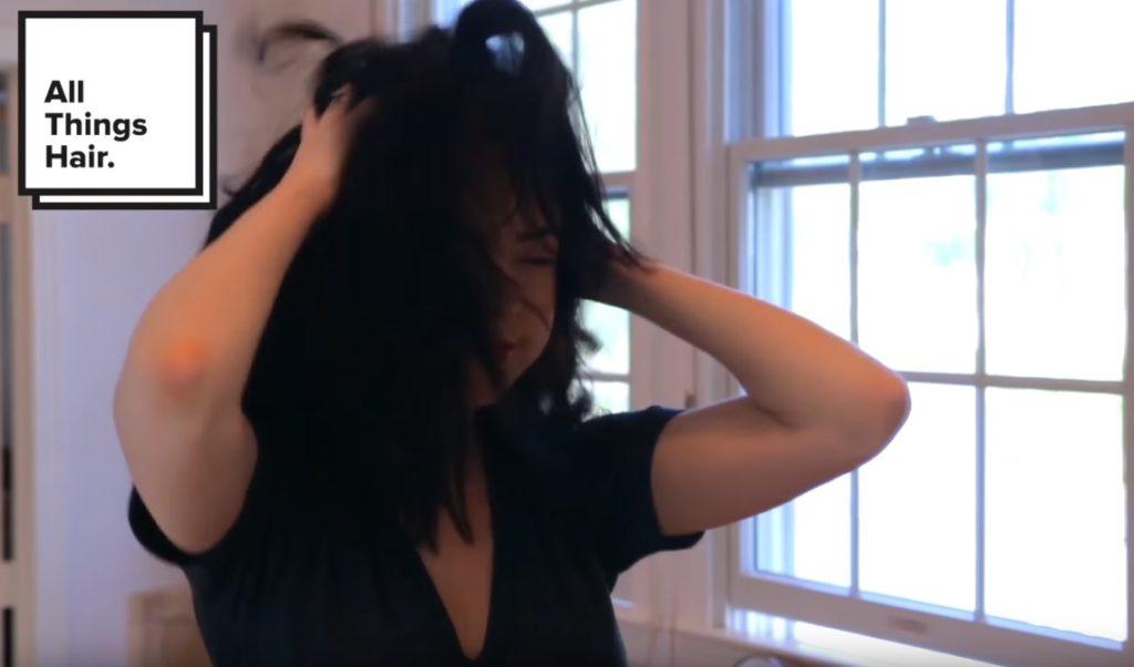 youtuber Nikki Phillippi drying her brunette hair