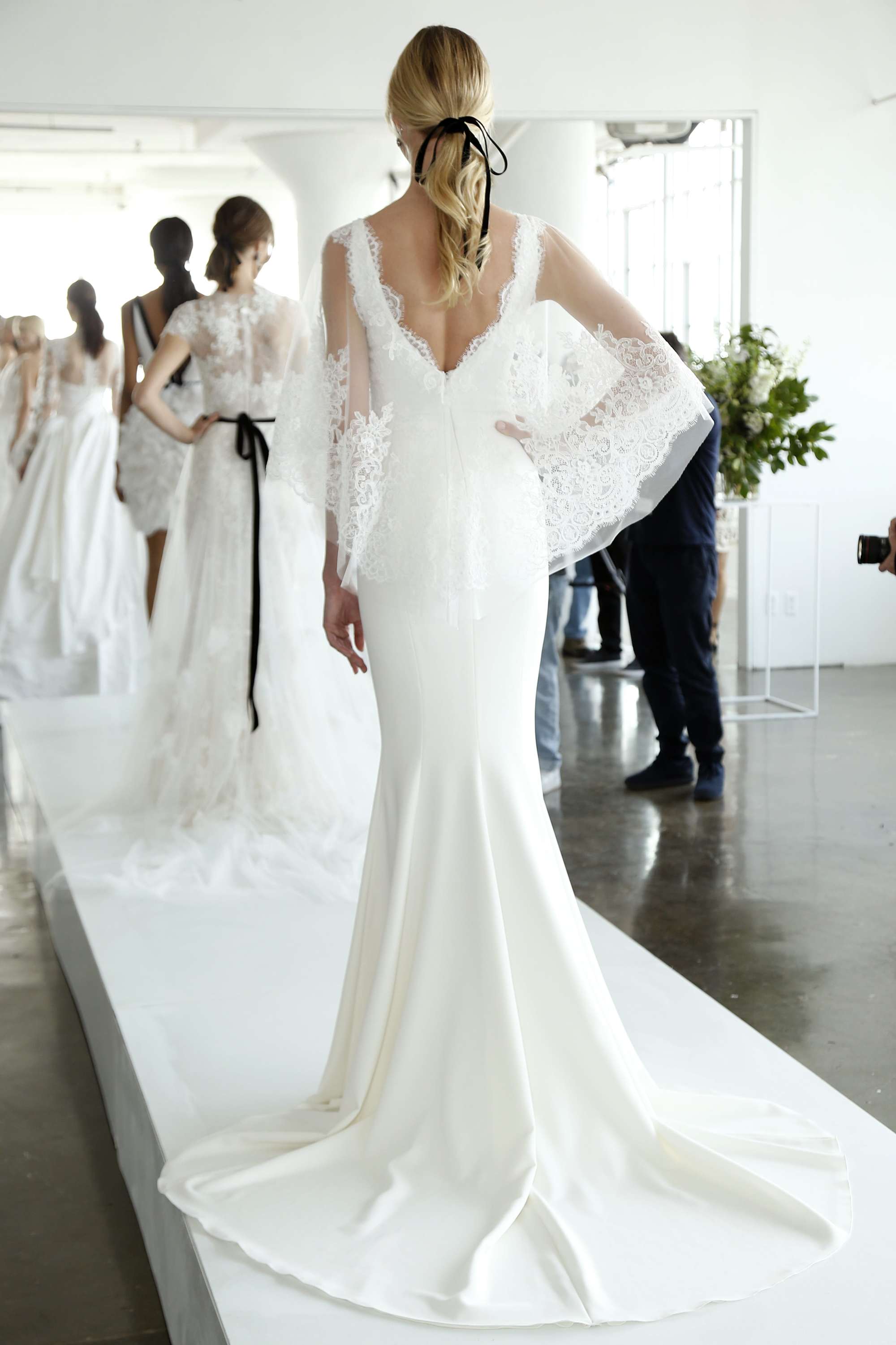 wedding hair trends: wavy low ponytail with black bow on the marchesa runway